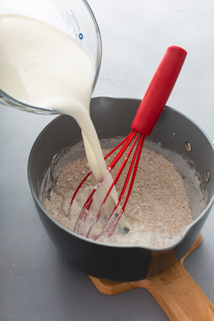 pouring milk over the caramel sauce