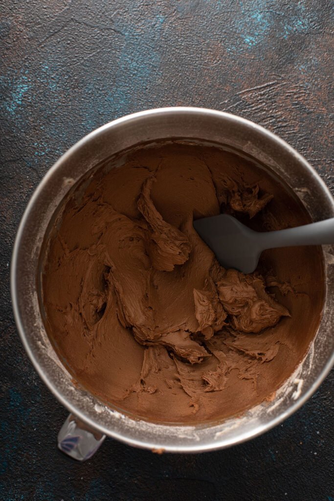chocolate buttercream on a large mixing bowl