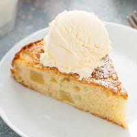 cake slice with fresh apples topped with vanilla ice cream