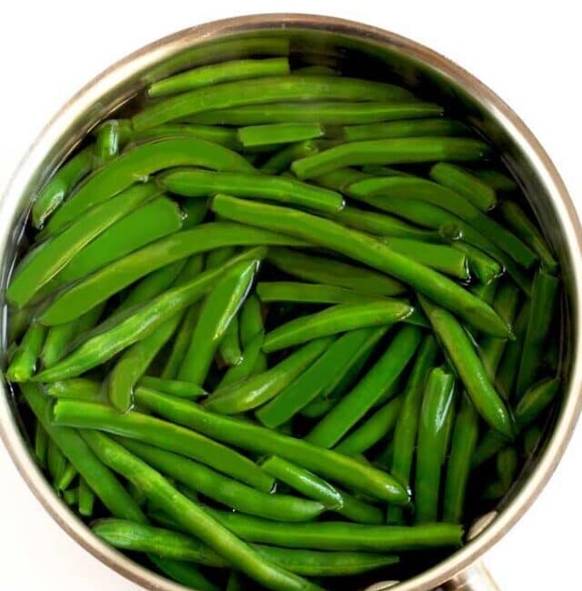 Blanched green beans or string beans in a pot of water