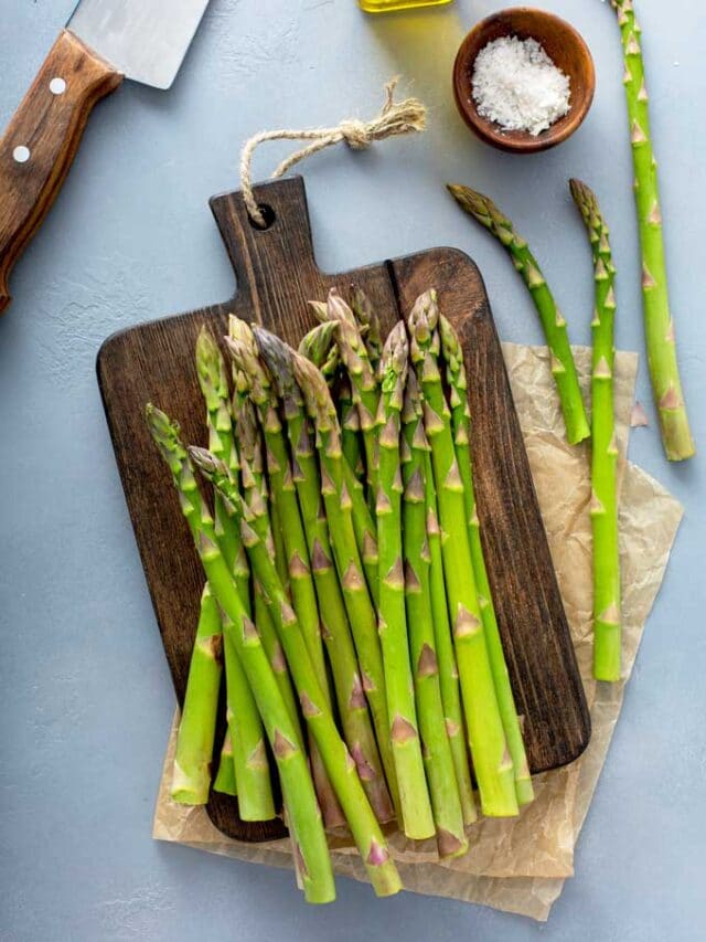 Trimming asparagus on a wooden board