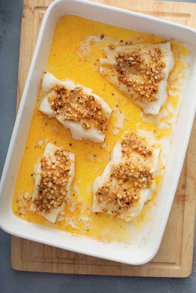 Baked Cod seasoned with flavorful Cajun butter right off the oven