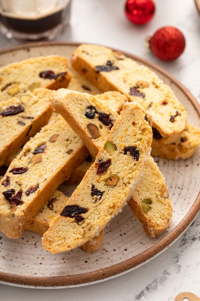 A plate with biscotti with pistachios and cranberries