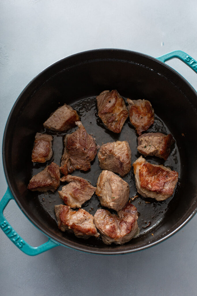 Pork seared and browned in dutch oven for Chile Verde. 
