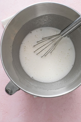 whisked egg whites with a whisk in a mixing bowl