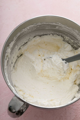 Fluffy and smooth Swiss meringue buttercream in a metal mixing bowl