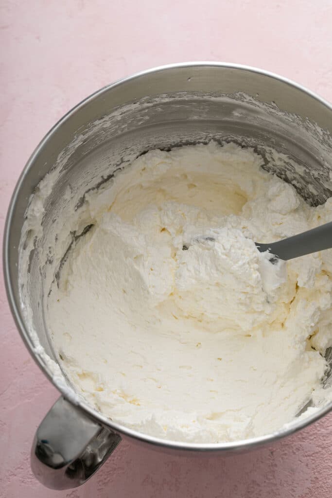 Step by step photos on how to make Swiss buttercream - Fluffy and smooth Swiss meringue buttercream in a metal mixing bowl