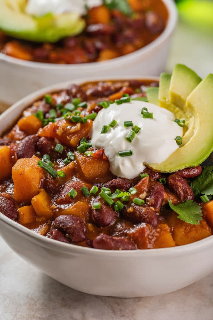 a white bowl filled with sweet potato and beans chili