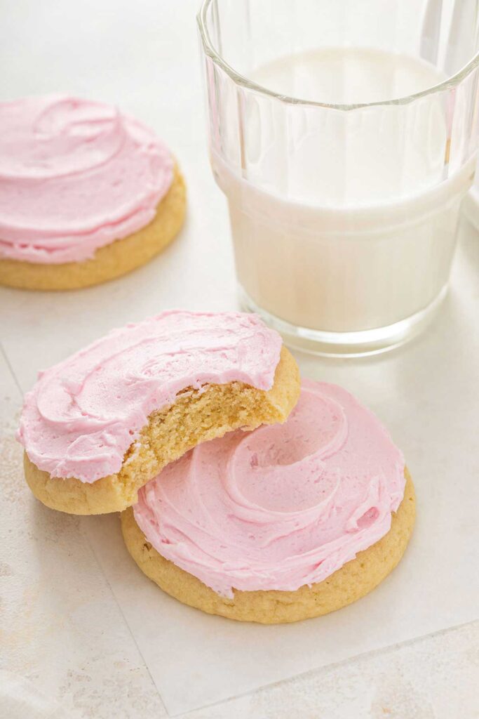 Cookies on a plate, one of them cut up to show the soft center.