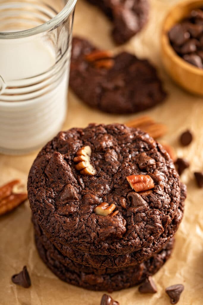 Photo showing the top of a double chocolate cookie studded with pecans and chocolate chips.