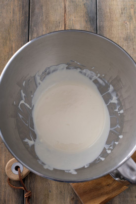 whisked eggs and sour cream in the bowl of an standing mixer