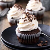 Guinness chocolate cupcakes with Irish cream frosting on a black plate