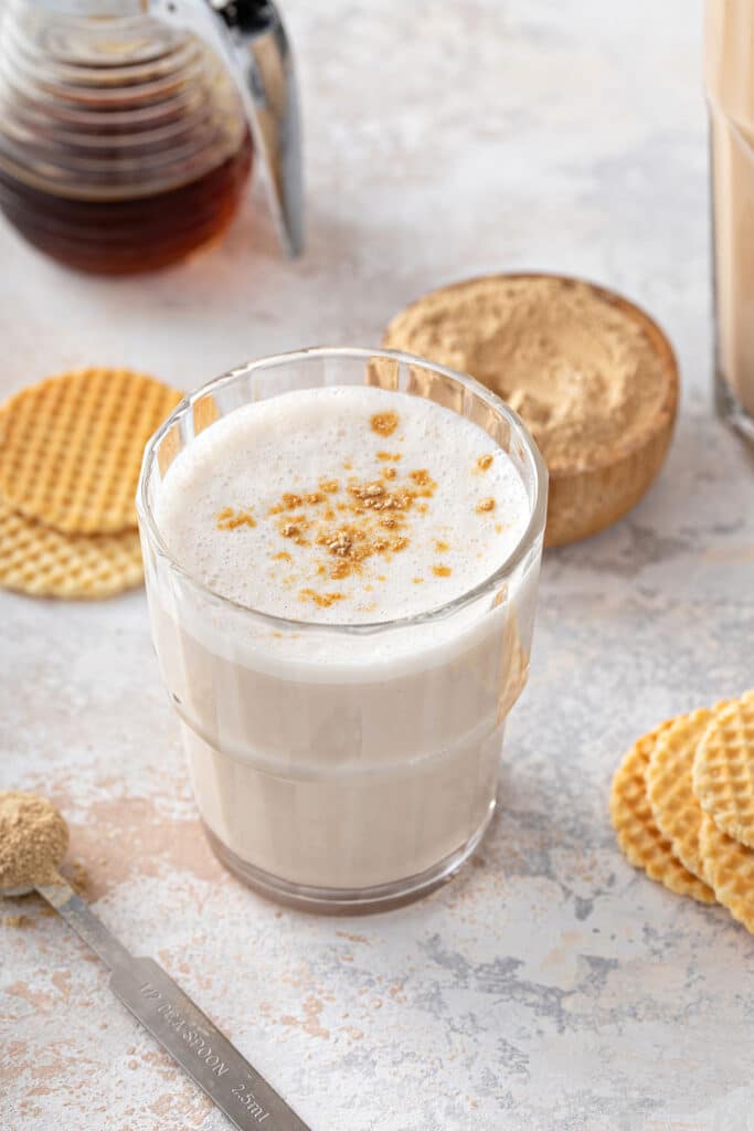 Foamy maca latte in a glass for hormonal balance