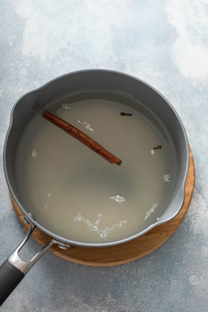 cooking rice in water with a cinnamon stick