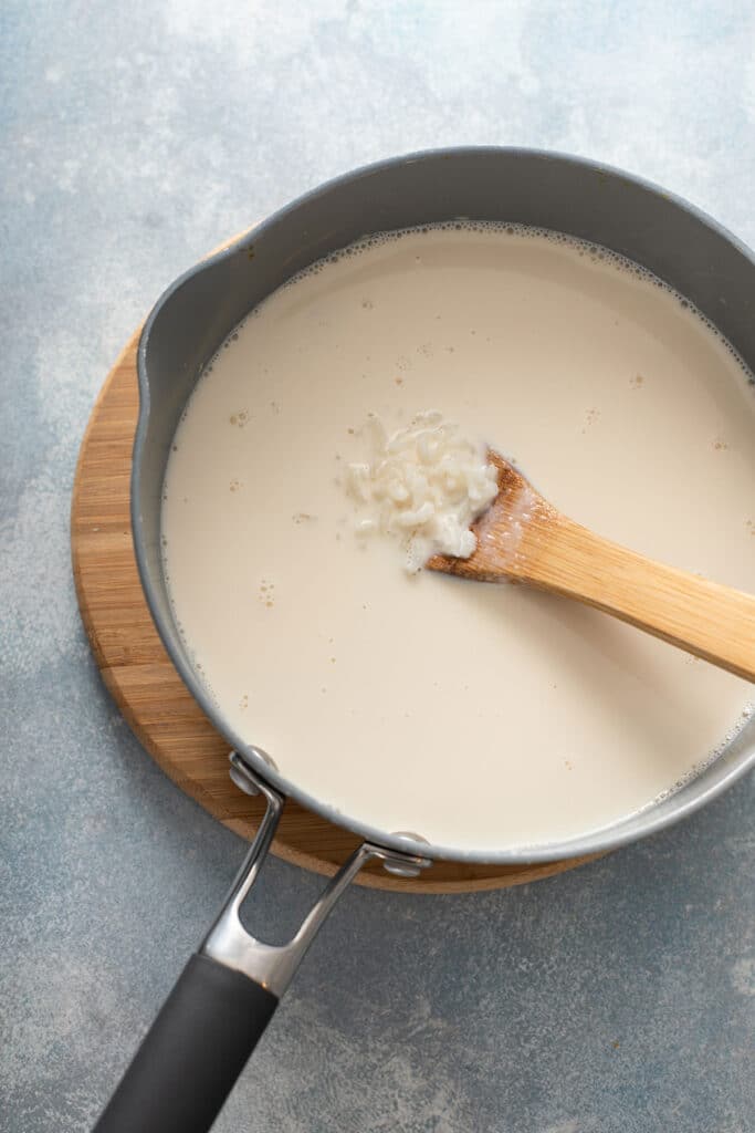 cooking rice with milk in a pot