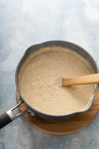 rice pudding in a pot with a wooden spoon