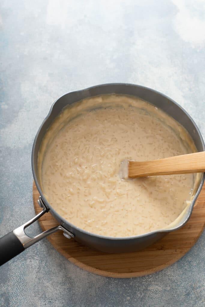 rice pudding in a pot with a wooden spoon