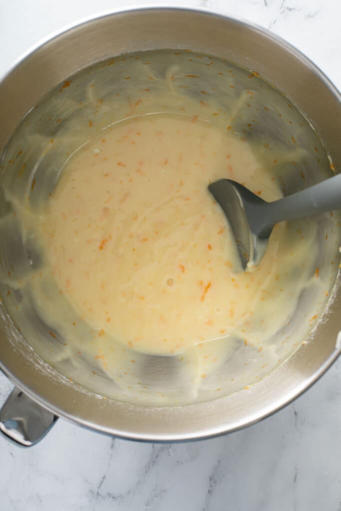 All the ingredients for the cream cheese orange glaze in a mixing bowl.
