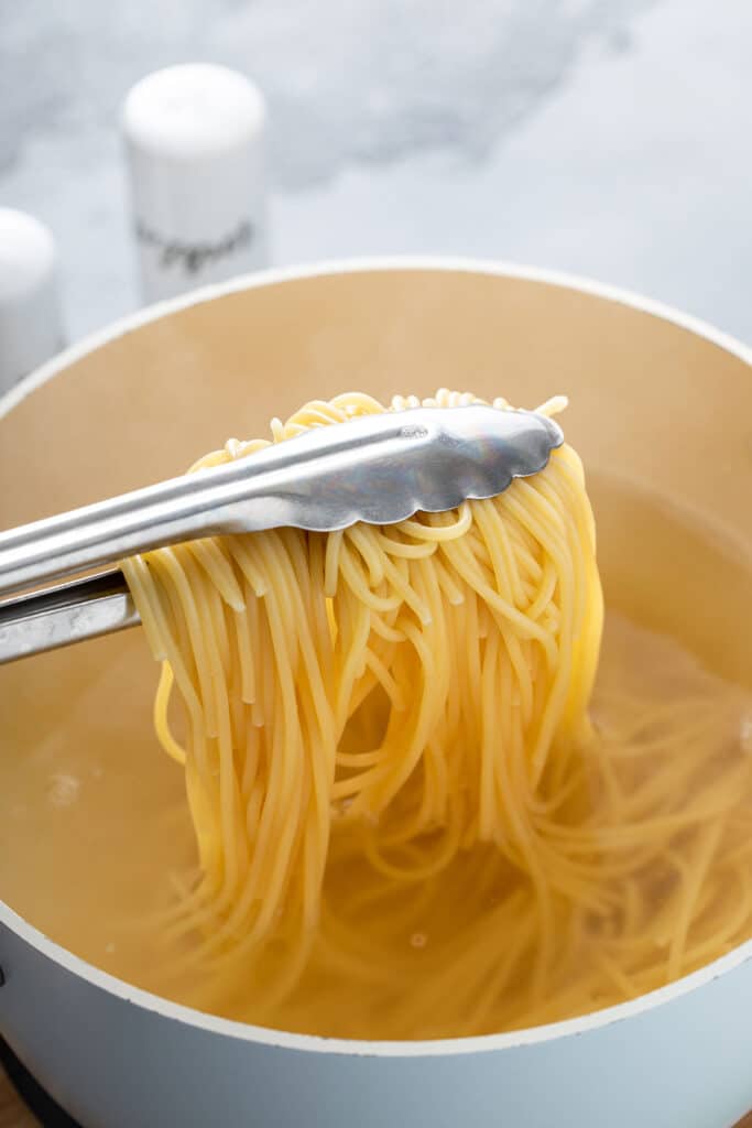 Pasta boiled in pot with water and salt until al dente. 