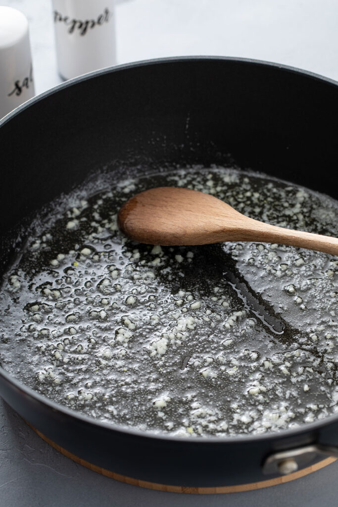 Butter melted in skillet with garlic added and sauteed. 