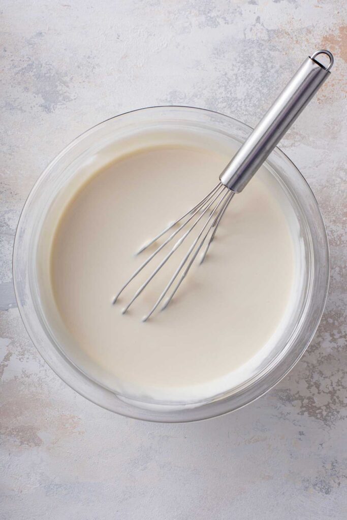 A glass bowl filled with the the crema sauce mixture.