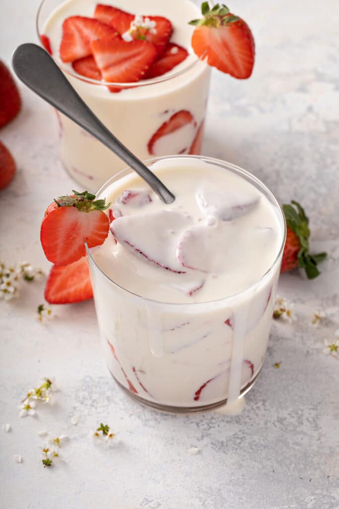 Rich and creamy sauce served with strawberries in a glass jar