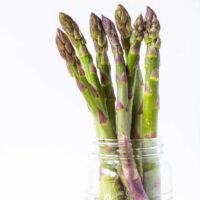 asparagus spears inside a glass jar