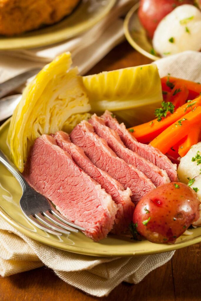 Slices of corned beef with potatoes, carrots and cabbage on a plate