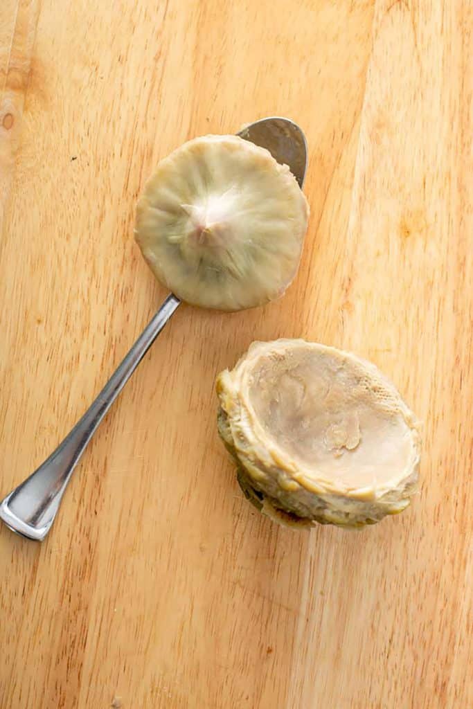 an artichoke heart with a spoon