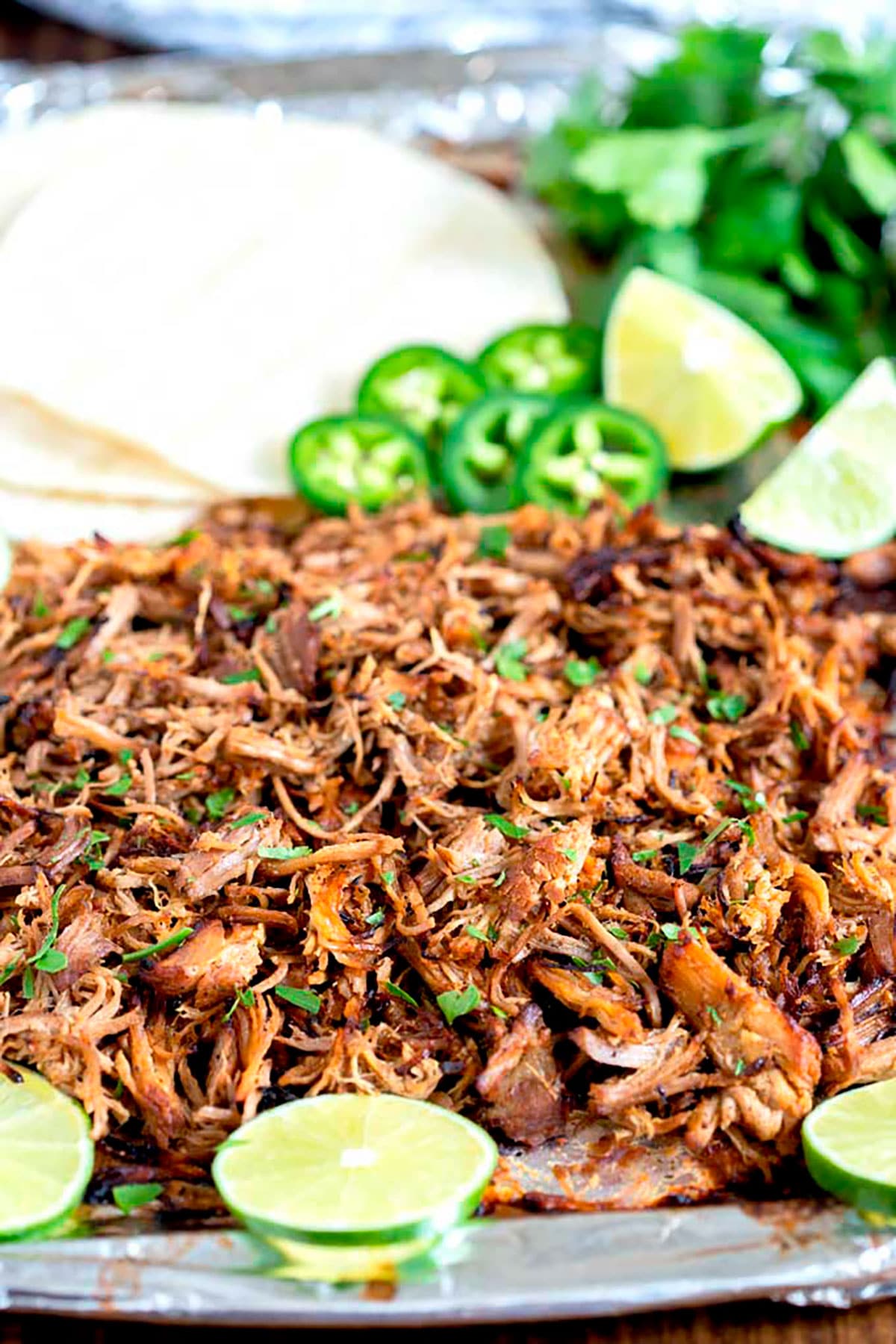 Shredded beef carnitas with crispy tops on a sheet pan