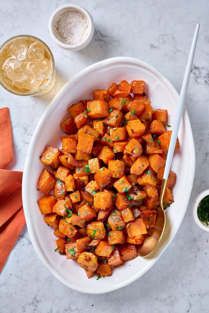 Top view of maple sweet potatoes in a baking sheet.