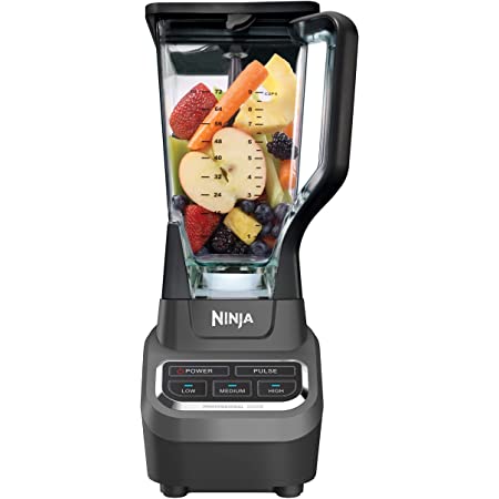 A black ninja blender with fruit inside de blender cup