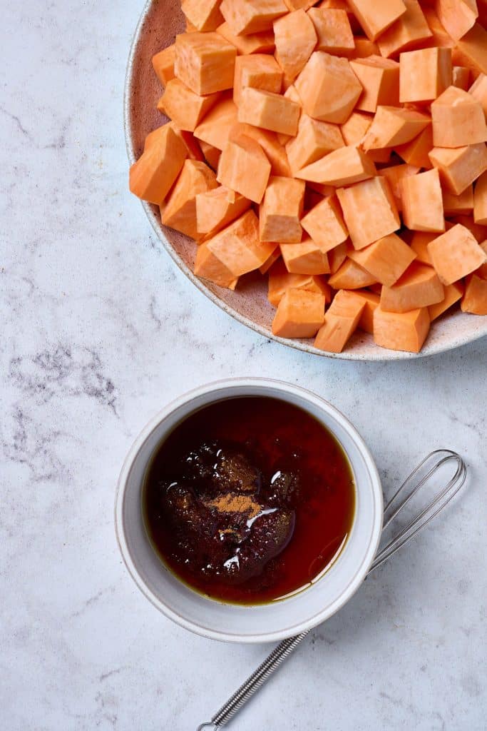 maple syrup mixture next to sweet potatoes in a bowl
