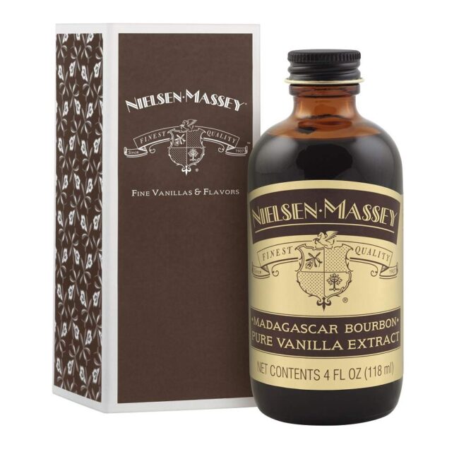 A bottle of Nielsen Massey vanilla extract next to its brown box