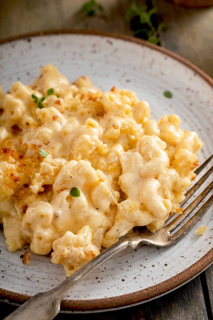 Plate filled with creamy mac and cheese with crispy topping