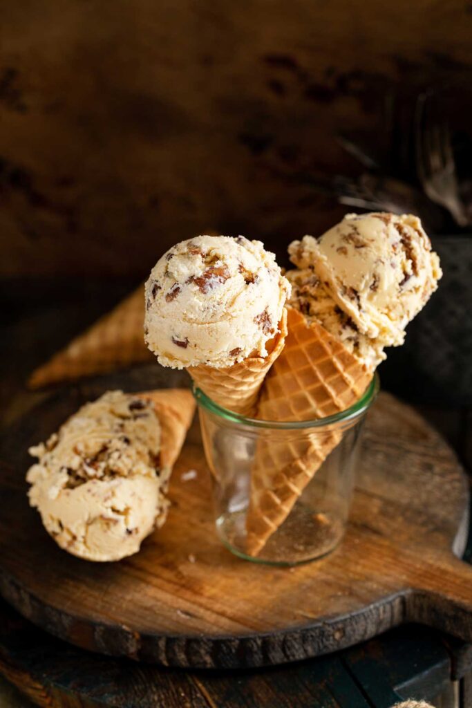 Butter pecan ice cream scoops on ice cream cones 