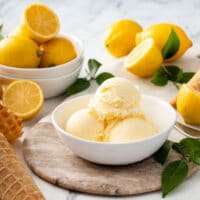 A bowl with three scoops of lemon ice cream