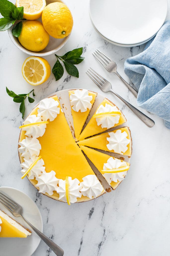A lemon cheesecake with a few cut up slices.