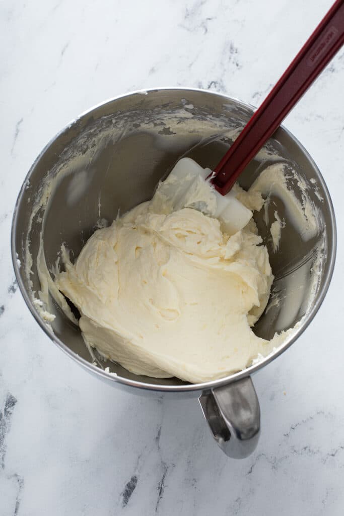 smooth cream cheese and lemon sugar mixture with eggs, vanilla extract, lemon juice, and heavy cream mixed in stand mixer or handheld mixer 