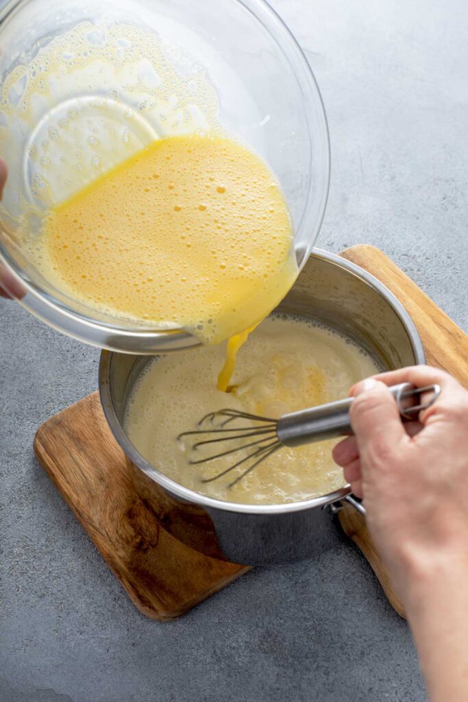 egg yolk mixture being stirred into saucepan for about 10 minutes on medium-low heat. 