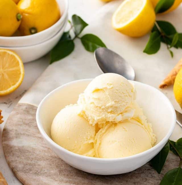 A white bowl with 3 scoops of lemon ice cream