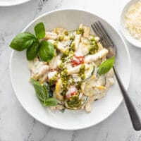 Creamy casarecce pasta with ricotta, basil pesto and veggies
