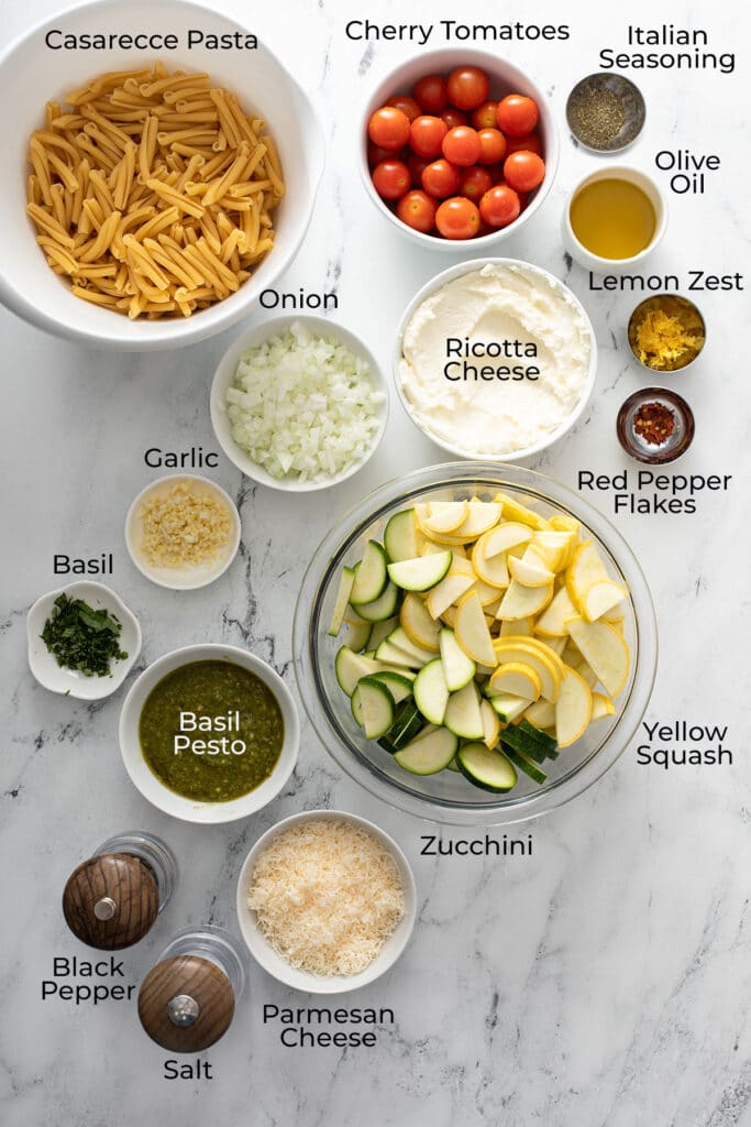 Ingredients to make vegetarian pasta with summer squash, ricotta and pesto.