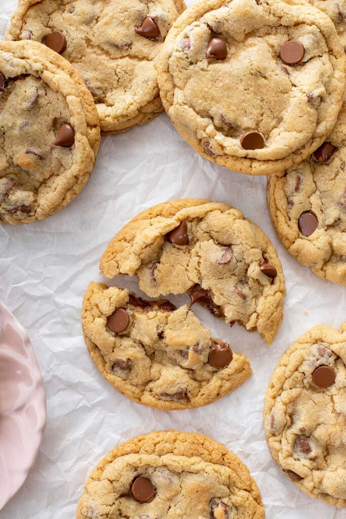 Copycat crumbl chocolate chip cookies on a piece of parchment paper. 