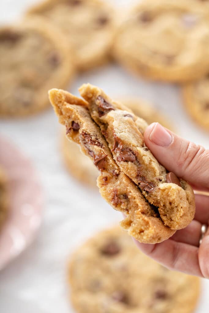 Chocolate chip cookie cut in half showing the soft and gooey inside
