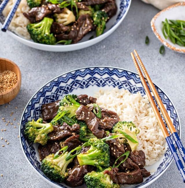 Two bowl with beef and broccoli with a side of white rice