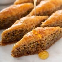 Baklava getting drizzled with honey