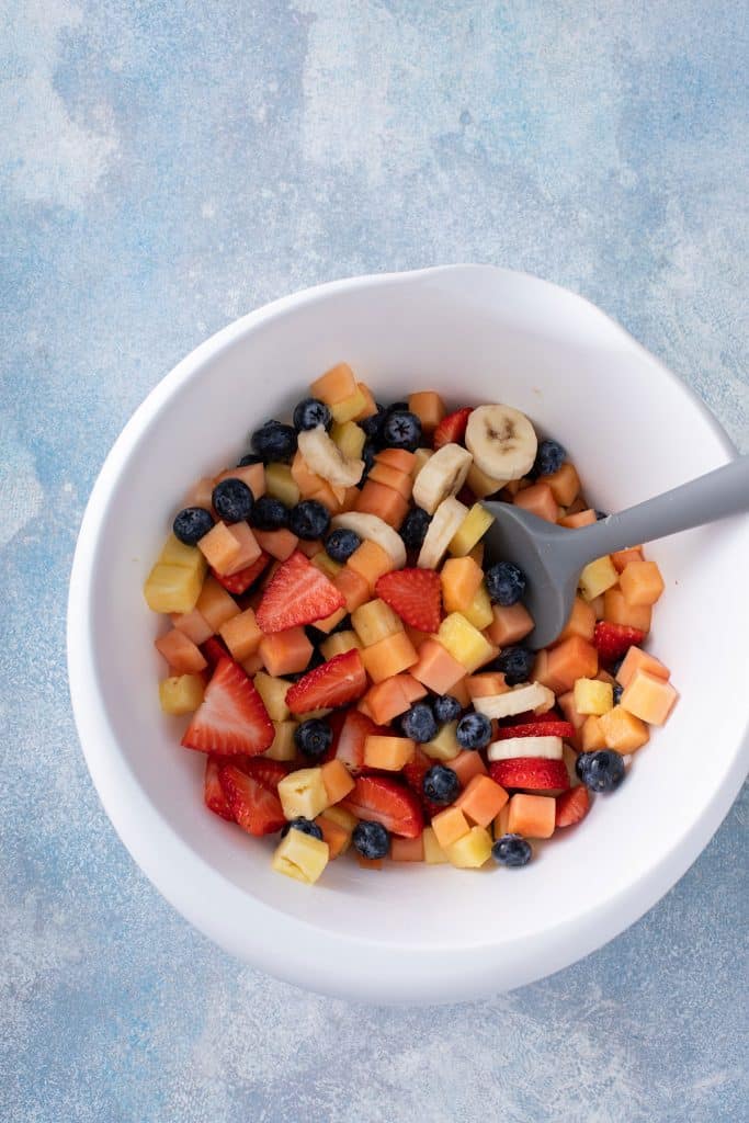 Chopped fruit in a large bowl.