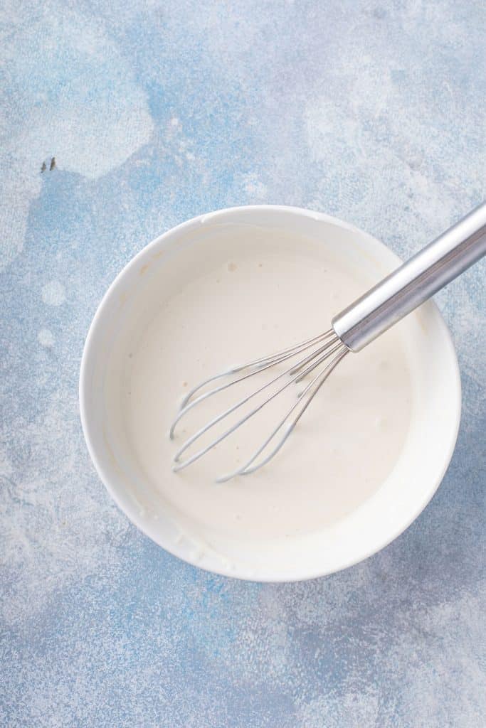 sour cream, plain yogurt, condensed milk and vanilla extract combined in a mixing bowl.