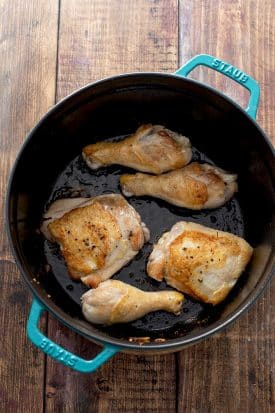 Sautéing chicken legs and thighs in a pot